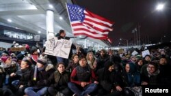 People gather to protest against the travel ban imposed by U.S. President Donald Trump's executive order, at O'Hare airport in Chicago, Illinois, Jan. 28, 2017.