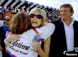 FILE - Marla Maples and her husband Donald Trump greet race driver Lyn St. James prior to the inaugural Indy 200 race at Walt Disney World.