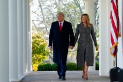 President Donald Trump and first lady Melania Trump walk out of the Oval Office and towards the Rose Garden of the White House, Tuesday, Nov. 24, 2020, in Washington, to pardon Corn, the national Thanksgiving turkey. (AP Photo/Susan Walsh)