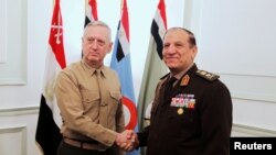 FILE - Egypt's Chief of Staff of the Armed Forces Sami Anan, right, shakes hands with the U.S. Commander of the Central Command James Mattis during a meeting in Cairo, Egypt, March 29, 2011.
