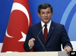 FILE - Then-Turkish Prime Minister Ahmet Davutoglu speaks to the media at the headquarters of his ruling Justice and Development Party, AKP, in Ankara, Turkey, May 5, 2016.