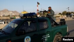 An Afghan policeman keeps watch at a checkpoint during parliamentary elections in Kabul, Afghanistan, Oct. 20, 2018.