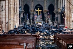 A hole is seen in the dome inside Notre Dame cathedral in Paris, Apr. 16, 2019.