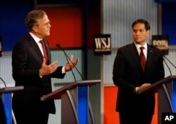Jeb Bush, left, speaks as Marco Rubio listens during Republican presidential debate at Milwaukee Theatre, Tuesday, Nov. 10, 2015, in Milwaukee.
