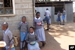 FILE - Pupils play during their lunch break at Mariakani Primary School in Nairobi, Kenya, July 27, 2015.
