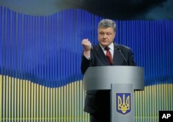 FILE - Ukrainian President Petro Poroshenko gestures while speaking during a news conference in Kyiv, Ukraine, Jan. 14, 2016.