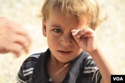 This child is with his family in the Hammam Alil camp near Mosul, Iraq, but many others have been separated from their parents in the chaos of the mass exodus from the battle zones, June 2, 2017. (H.Murdock/VOA)