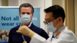 Governor Gavin Newsom watches as the Pfizer-BioNTech COVID-19 vaccine is prepared by Director of Inpatient Pharmacy David Cheng at Kaiser Permanente Los Angeles Medical Center in Los Angeles, California on December 14, 2020.