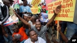 FILE - Demonstrators chant anti-electoral council slogans during a rally protesting against what they claim are fraudulent elections results in Port-au-Prince, Haiti, Dec. 16, 2015.