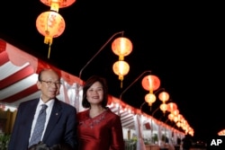 Dr. Mai-Phuong Nguyen, right, and her father, Son Van Nguyen, 76, pose for a photo in the Little Saigon area of Westminster, California, Jan. 11, 2017.