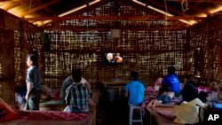 FILE - Young drug addicts watch television at a drug rehabilitation center run by the Kachin Baptist Community at Nampatka Village, Northern Shan State, Myanmar.