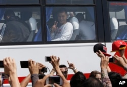The Houston Rockets' Jeremy Lin waves to Filipino fans upon arrival on Oct.7, 2013, at the Ninoy Aquino International Airport south of Manila, Philippines, for the first NBA game ever played in the basketball-crazy Southeast Asian nation.