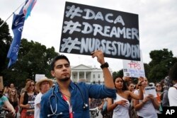 FILE - Carlos Esteban, 31, of Woodbridge, Va., a nursing student and recipient of Deferred Action for Childhood Arrivals, known as DACA, rallies with others in support of DACA outside of the White House, in Washington, Sept. 5, 2017.