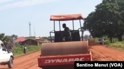 A worker flattens a mix of gravel and dirt on the main road connecting the capital of Warrap state in South Sudan to the town of Tharkueng, 30 kilometers away. State officials began repairing the road in Sept. 2014.
