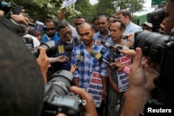 Imam Maulama Akonjee's son Saif Akonjee speaks to media at the Queens Criminal Court before the arraignment of alleged murderer Oscar Morel in Queens, New York, Aug. 16, 2016.