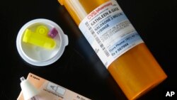 FILE - A nasal dose of Narcan is seen Pilgrim High School in Warwick, R.I., Sept. 2, 2015. A new state law requires middle and high schools to stock Narcan, which can reverse the effects of an overdose of drugs such as heroin or prescription painkillers.