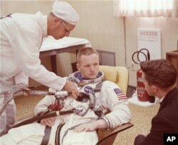 FILE - In this March 9, 1966 file photo, astronaut Neil Armstrong is seated during a suiting up exercise Cape Kennedy, Fla., in preparation for the Gemini 8 flight.
