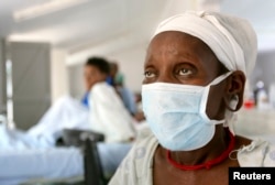 FILE - A patient who tested positive for extensively drug-resistant tuberculosis (XDR-TB) awaits treatment at a rural hospital in South Africa's impoverished KwaZulu-Natal province.