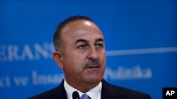 FILE - Turkey's Foreign Minister Mevlut Cavusoglu, listens to a reporter's question during a joint news conference with Russia's Foreign Minister Sergey Lavrov (not pictured), in Ankara, Turkey, Aug. 14, 2018.