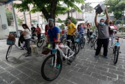 Winners of the Benjamin Canlas Courage to be Kind Foundation get their bicycles in the financial district of Manila, Philippines, July 11, 2020.