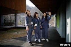Park Hye-ri (L), 28, a startup business program manager, takes a selfie with her friends before being locked up at Prison Inside Me, a mock prison facility, in Hongcheon, South Korea, November 10, 2018. (REUTERS/Kim Hong-Ji)