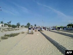 Egyptians gather outside the Rawda mosque, roughly 40 kilometers west of the North Sinai capital of El-Arish, following a gun and bombing attack, on Nov. 24, 2017.