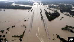 FILE - In this Aug. 29, 2017 file photo, Interstate 69 is covered by floodwaters from Harvey, in Humble, Texas.