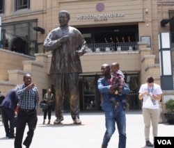 One of the places featured on the board of Monopoly Mzansi is Sandton Square, where a huge statue of Nelson Mandela is a major attraction. (D. Taylor for VOA)