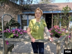 Pamela Taylor stands outside her ranch home in Brownsville, Texas, where she has lived for nearly 70 years. Following the 2006 Secure Fence Act, a barrier was built to her north, with an opening just big enough for two-lane traffic. (R. Taylor/VOA)