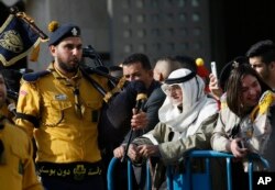 Palestinians watch a performance by Christian scouts at Manger Square, outside the Church of the Nativity in the West Bank City of Bethlehem, Dec. 24, 2016.