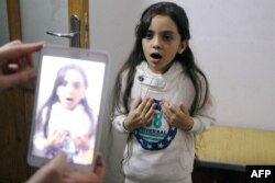 Syrian Bana al-Abed is filmed by her mother as they prepare to post on Twitter in English about life in the besieged eastern districts of Syria's Aleppo, Oct. 12, 2016.