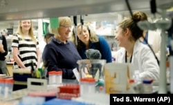 U.S. Sen. Patty Murray visits with lab technician Kennidy Takehara in a research lab at the University of Washington's UW Medicine South Lake Union Campus.
