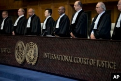 Judges enter the International Court of Justice, or World Court, in The Hague, Netherlands, Wednesday, Oct. 3, 2018, where they ruled on an Iranian request to order Washington to suspend U.S. sanctions against Tehran.