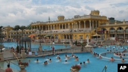 The Neo-Baroque building at Szechenyi Bath and Spa surrounds the outdoor pools, Budapest.