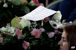 A message is seen during the state funeral service of some of the earthquake victims in Ascoli Piceno, Italy, Aug. 27, 2016.
