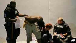 Police detain two people during protests following the police shooting of Keith Lamont Scott, in Charlotte, North Carolina, Sept. 21, 2016.