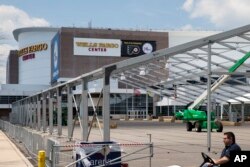 FILE - Temporary structures go up outside the Wells Fargo Center ahead of the 2016 Democratic National Convention in Philadelphia, June 20, 2016.