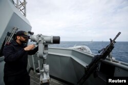 FILE - A crew member is seen on the deck of Spain's navy frigate Mendez Nunez as it participates in NATO exercises in the Mediterranean sea, March 13, 2017.