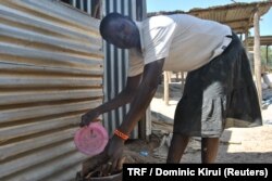 A woman roasting gold ore with mercury at the Osiri-Matanda gold mine in Nyatike in Migori county, Kenya, Feb. 3, 2018.