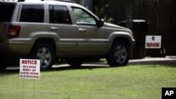 FILE - "No trespassing" signs adorn the lawn of Carolyn Donham's Greenville, Miss., home, Aug. 12, 2005. Donham, formerly Carolyn Bryant, was in 1955 the wife of Roy Bryant. Bryant and his half brother, J.W. Milam, allegedly abducted, tortured and killed 14-year-old Emmett Till, a black youth from Chicago who was visiting relatives when he made the mistake of whistling at Bryant's wife.