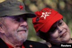 Former Brazilian President Luiz Inacio Lula da Silva, left, and Former Brazilian President Dilma Rousseff are seen wearing party caps during the opening ceremony of the national congress of the Workers' Party in Brasilia, Brazil, June 1, 2017.