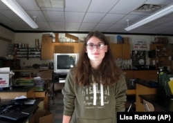 In this December 11, 2017 photo, Kimberly Taylor, one of three high school students remaining at the Rochester School, stands in an empty science classroom at the school in Rochester, Vermont.