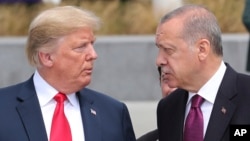 FILE - President Donald Trump, left, talks to Turkish President Recep Tayyip Erdogan, right, as they tour the new NATO headquarters in Brussels, July 11, 2018.