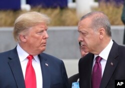 President Donald Trump, left, talks to Turkish President Recep Tayyip Erdogan, right, as they tour the new NATO headquarters in Brussels, Belgium, July 11, 2018.