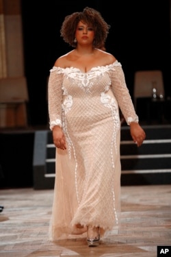 A plus-size model walks the runway during a fashion show as part of a day against fat phobia in Paris, Dec. 15, 2017. Paris is looking at its rising obesity levels and launching a campaign against an often disregarded kind of discrimination: sizeism.