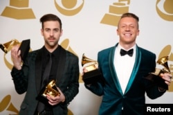 FILE - Hip hop artists Macklemore (R) and Ryan Lewis pose backstage with their awards for Best New Artist, Best Rap Performance for "Thrift Shop", Best Rap Song for "Thrift Shop" and Best Rap Album for "The Heist", Jan. 26, 2014.