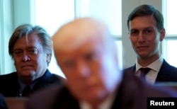 FILE - Trump advisers Steve Bannon, left, and Jared Kushner, right, listen as U.S. President Donald Trump meets with members of his Cabinet at the White House in Washington, June 12, 2017.
