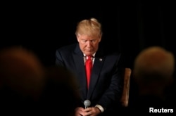 Republican presidential nominee Donald Trump pauses before answering questions at the "Retired American Warriors" conference during a campaign stop in Herndon, Virginia, Oct. 3, 2016.