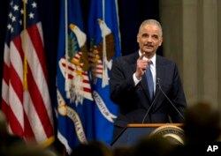 Attorney General Eric Holder speaks at a farewell gathering at the Justice Department in Washington, April 24, 2015. Holder was bidding farewell to the Justice Department after six years as the nation's top law enforcement official.