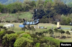 FILE - A Terminal High Altitude Area Defense (THAAD) interceptor (right) is seen in Seongju, South Korea, April 26, 2017.